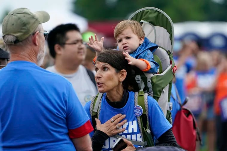 Deborah Plotkin carries her grandson as she attends the second March for Our Lives rally in support of gun control in front of the Washington Monument on Saturday.