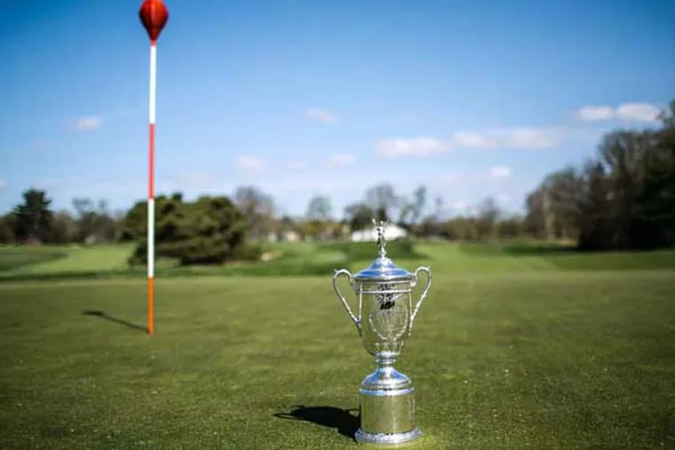 A replica of the US Open trophy on the 18th hole green of the East Course of Merion Golf Club. The 113th US Open will be held at Merion Golf Club from June 13-16. (Colin Kerrigan / Philly.com)