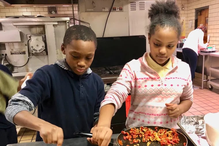 Bayard Taylor chefs Nathaniel Trewick and Dairis Berge team up to fill the colorful taco shells with turkey during the fall 2019 semester of My Daughter's Kitchen.