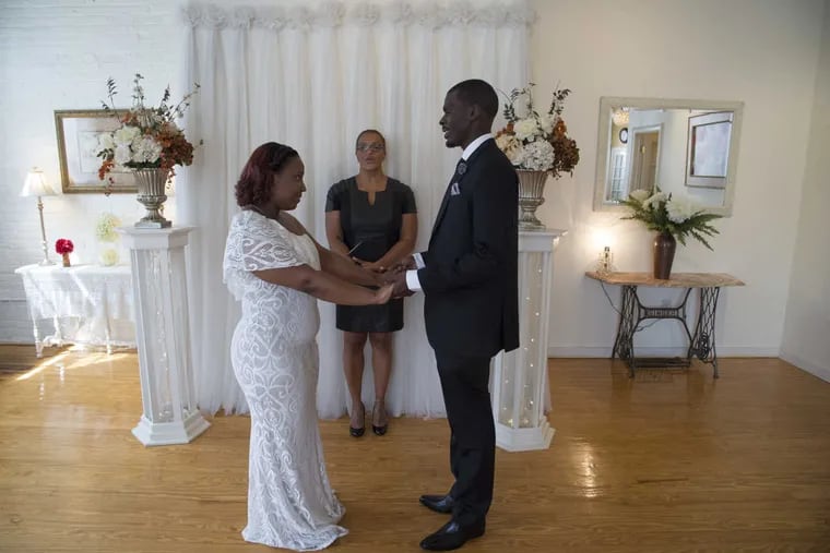 Stacey Thomas, an ordained wedding minister and owner of the Philadelphia Wedding Chapel, performs the marriage ceremony for Franchesca Henry, 24, and Henry Parker, 32, both of Germantown, on September 26, 2016.   CLEM MURRAY / Staff Photographer