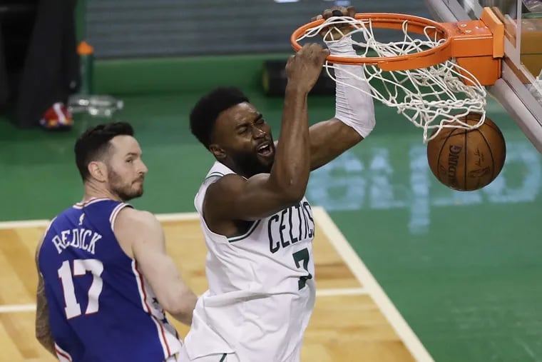 Celtics guard Jaylen Brown dunks the basketball as Sixers guard JJ Redick looks on during the Sixers’ Game 2 loss on Thursday.