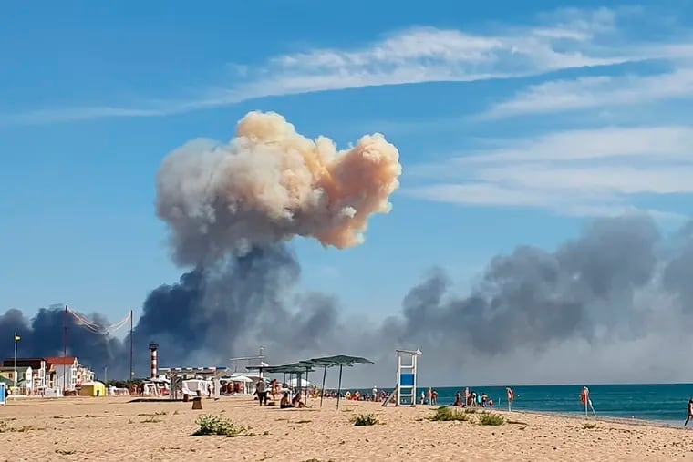 Rising smoke can be seen from the beach at Saky after explosions were heard from the direction of a Russian military airbase near Novofedorivka, Crimea, on Tuesday.