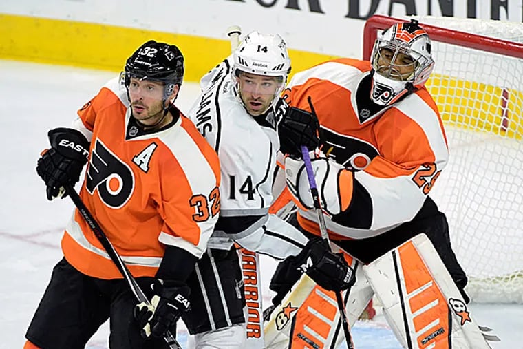 Kings right wing Justin Williams is caught between Flyers defenseman Mark Streit and goalie Ray Emery. (Eric Hartline/USA Today Sports)