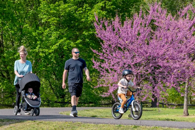 Sam and Ashley Koch, with Mash, 4, and Nixon, 7 months old, of Cherry Hill walk in the township's Challenge Grove Park April 27, 2021.