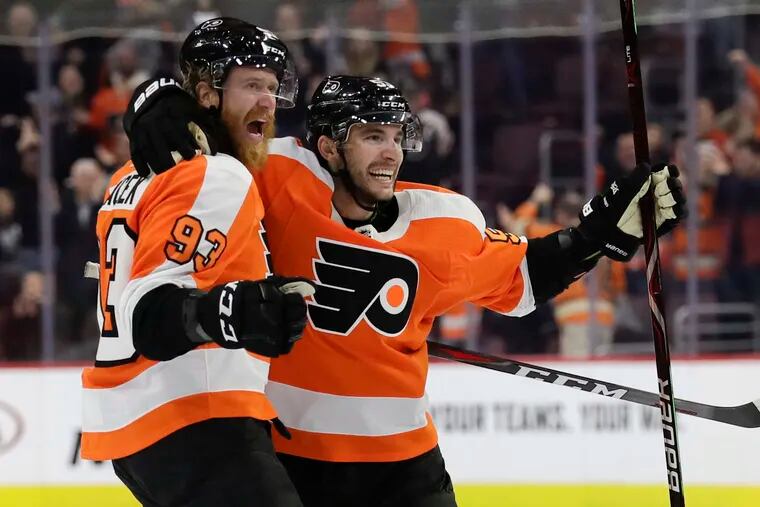 Flyers right winger Jake Voracek (left) celebrates with Shayne Gostisbehere after a late game-tying goal against Los Angeles last month.