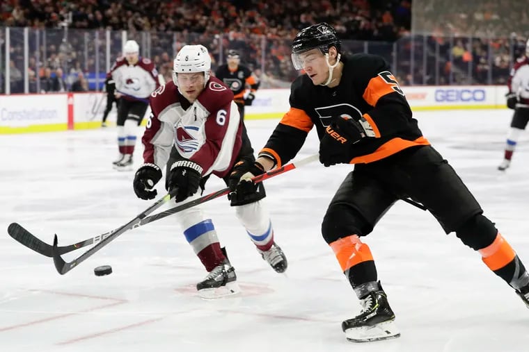 With his long reach, Flyers defenseman Phil Myers (right) goes after the puck against Colorado's Erik Johnson in a game last season. Myers signed a three-year contract extension Tuesday.