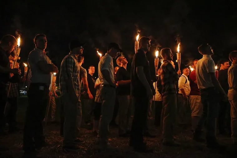 Multiple white nationalist groups march with torches through the UVA campus in Charlottesville on Friday.