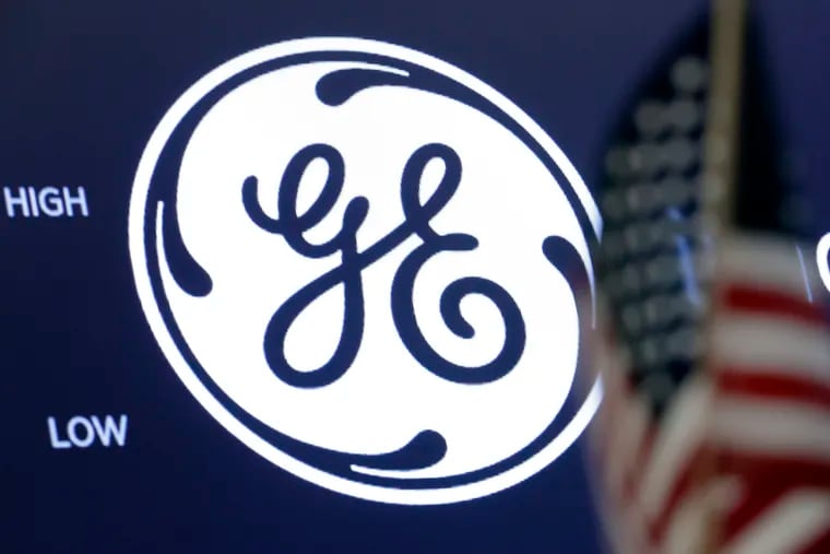 The General Electric logo appears above a trading post on the floor of the New York Stock Exchange.