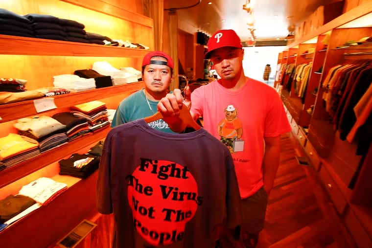 Ky Cao, at right, and his brother, Rick Cao, at left, owners of Ps & Qs menswear boutique in South Philly, created a "Fight The Virus Not The People" shirt project to speak out against racism in the wake of the coronavirus.