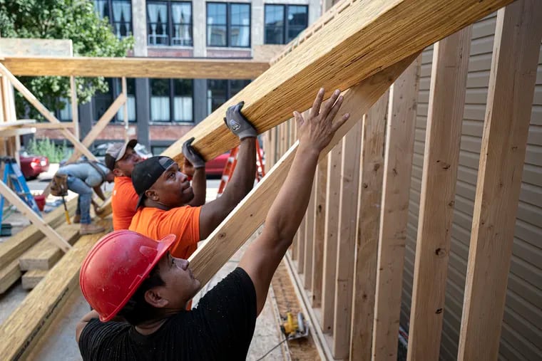 Contractor Jesse Fells works on a property in Fishtown. Fells, a graduate of Kensington High, is a developer who relies on Philadelphia-based Spring Garden Capital's lending arm to finance construction of the homes he builds.