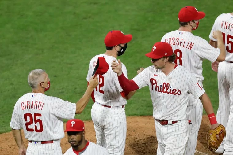 Mmanager Joe Girardi and first baseman Rhys Hoskins celebrated after the Phillies shut out the Atlanta Braves, 5-0, on Aug. 8.
