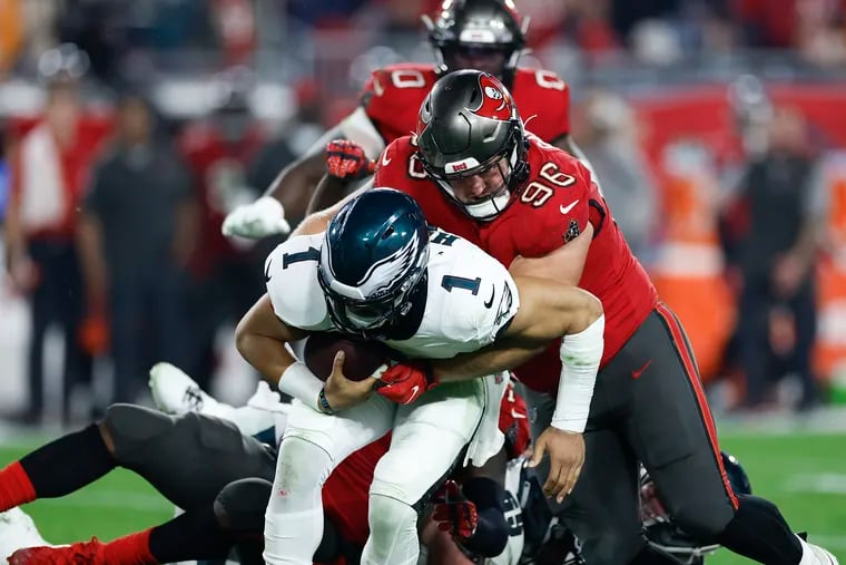 Eagles quarterback Jalen Hurts is sacked by Tampa Bay defensive tackle Greg Gaines during the Buccaneers' playoff win on Jan. 15.