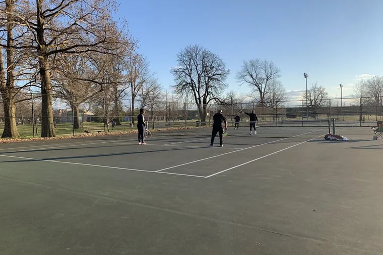 Coronavirus fears didn't keep tennis players off Fairmount Park courts in Stawberry Mansion on Sunday, March 15.