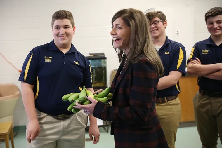 First Lady of New Jersey Tammy Murphy, second from left, receives a gift of greenhouse-grown bananas from sophomore Nick Lewis, 15, left, and other FFA student officers at Northern Burlington County Regional High School in Columbus, N.J. in 2020. Murphy announced her run for Senate on Wednesday.