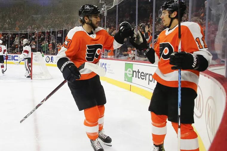 Flyers center Travis Konecny celebrates his first-period goal with teammate defenseman Shayne Gostisbehere against the New Jersey Devils on Saturday, January 20, 2018 in Philadelphia. YONG KIM / Staff Photographer