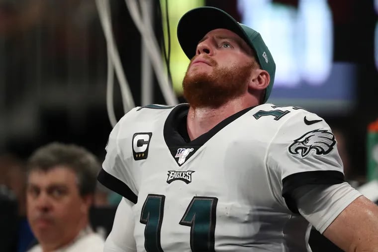 Eagles quarterback Carson Wentz  watches from the bench late in the 2nd quarter as the Philadelphia Eagles play the Atlanta Falcons in Atlanta, GA on September 15, 2019. .
