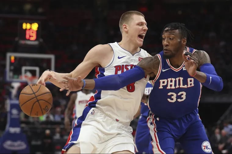 Sixers forward Robert Covington swipes at the ball as Pistons forward Henry Ellenson dribbles during the Sixers’ win.