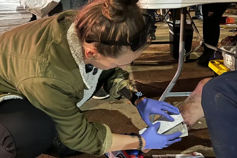 In Philadelphia's Kensington neighborhood, Stephanie Klipp, a wound care nurse, works to bandage a serious xylazine wound in danger of reaching this man's bone.