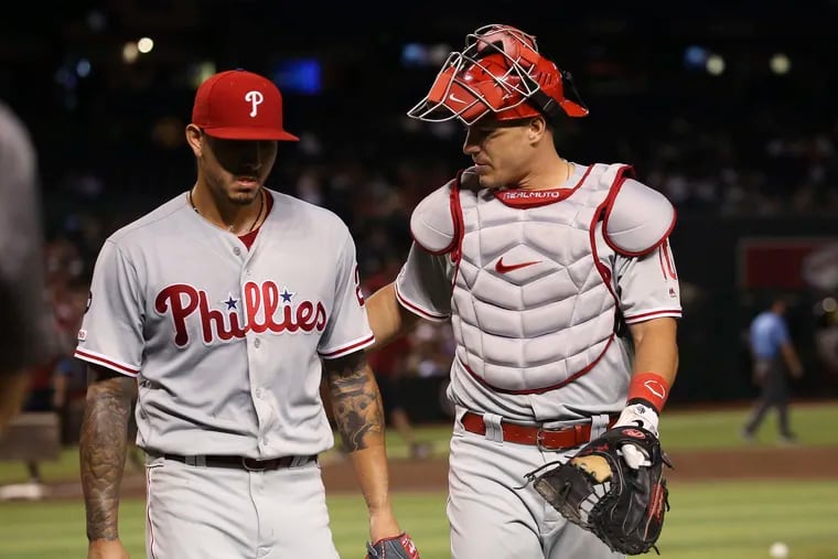 Catcher J.T. Realmuto, right, talks with starting pitcher Vince Velasquez, left, during the third inning the Phillies' 7-3 win over Arizona Monday night.