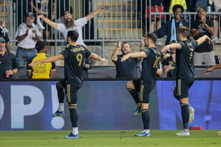From left, the Union's Julián Carranza, Dániel Gazdag, and Mikael Uhre pay tribute to the Eagles as they celebrate Uhre's goal.