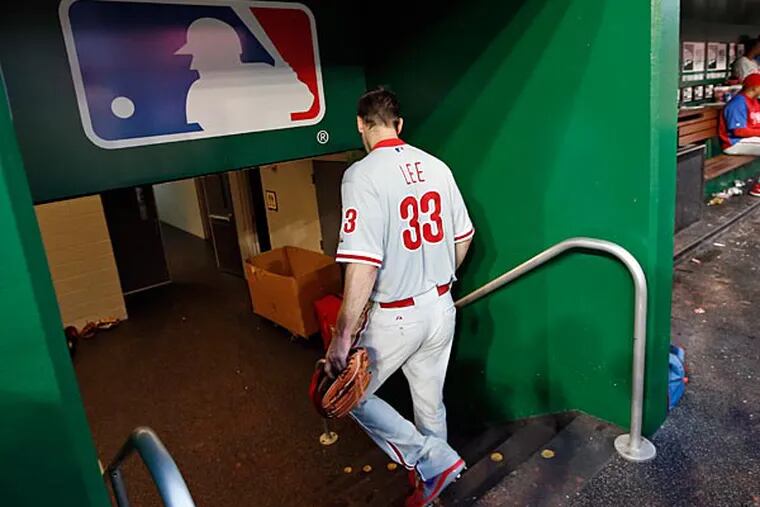 Cliff Lee (33) heads to the clubhouse in the fourth inning of a baseball game against the Washington Nationals at Nationals Park Thursday, July 31, 2014, in Washington. Lee left the game during the third inning. The Phillies announced that Lee had a recurrence of the left flexor pronator strain that sidelined him in May. (Alex Brandon/AP)