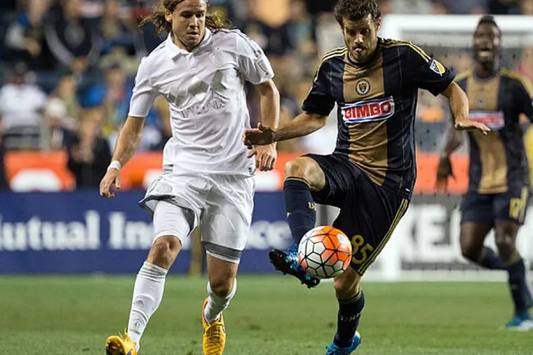 Philadelphia Union midfielder Tranquillo Barnetta (85) controls the ball past Sporting KC defender Chance Myers (7) during the first half at PPL Park.