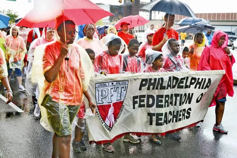 Members, family and friends of the Philadelphia Federation of Teachers march along Columbus Boulevard on Monday in the Philadelphia Council AFL-CIO's 26th annual Tri-State Labor Day Parade and Family Celebration. (TOM GRALISH / Staff Photographer)