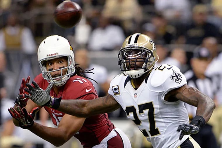 Safety Malcolm Jenkins (27) breaks up a pass intended for Arizona Cardinals wide receiver Larry Fitzgerald (11) in the second half of an NFL football game in New Orleans, Sunday, Sept. 22, 2013. (Bill Feig/AP file)