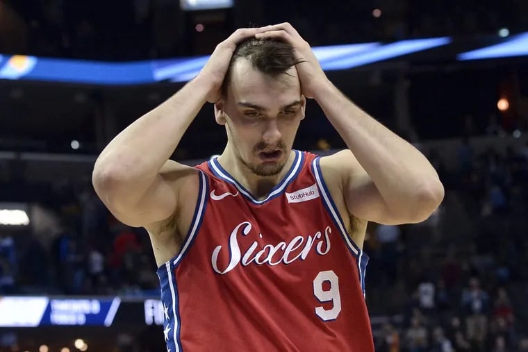 Sixers forward Dario Saric holds his head after the loss to the Grizzlies.
