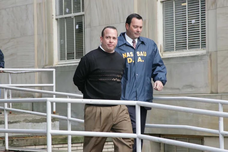 Joseph LaForte. a founder of Par Funding, has a criminal record.  In this 2005 photo, he is escorted out of Police Headquarters on Long Island,  N.Y.,  after he was charged in a $14 million financial scam.  (Photo by Ellis Kaplan)