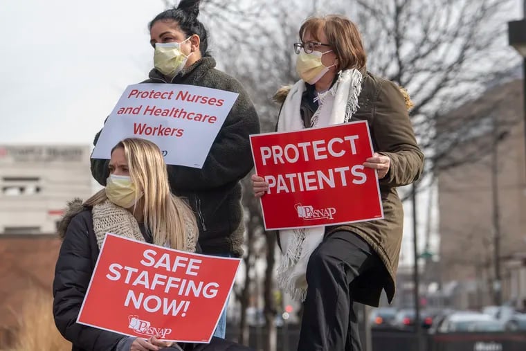 Nurses' unions have been lobbing for the Patient Safety Act. In this photo, health-care workers hold protest signs during a rally on Thursday, January 13, 2022, at Temple University Hospital in Philadelphia.