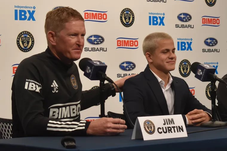 Union manager Jim Curtin (left) pats new 14-year-old player Cavan Sullivan (right) on the back during a news conference at Subaru Park on Thursday.