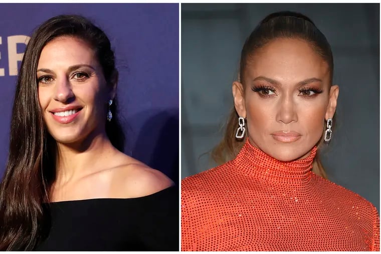 In this combination of file photos Carli Lloyd smiles prior to the women's soccer World Cup France 2019 draw, in Boulogne-Billancourt, outside Paris, on Dec. 8, 2018 and Jennifer Lopez attends the CFDA Fashion Awards at the Brooklyn Museum on June 3, 2019, in New York. Lloyd of the U.S. women's national soccer team celebrated her recent World Cup victory with a lap dance from J. Lo. Lopez pulled Lloyd from the audience to the stage at Madison Square Garden in New York on Friday, July 12, 2019, working her sensual moves on the soccer star.  (AP Photo)