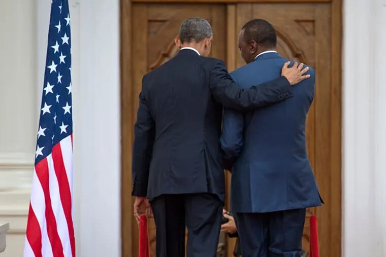 President Barack Obama, left, puts his arm on the shoulder of Kenyan President Uhuru Kenyatta as the two leave after speaking to the media at State House in Nairobi, Kenya, Saturday, July 25, 2015. (AP Photo/Ben Curtis)