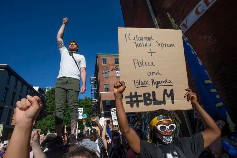 A rally and march through Philadephia was held to encourage city leadership to put city services for black, brown, and working class communities above funding for the Philadelphia Police Department on June 13, 2020. The crowd applauds a speaker near 3rd and Race Streets, the vicinity of the mayor’s home.
