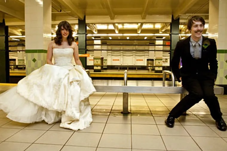 With echoes of the final scene of "The Graduate," Leann Greto and Matthew Ashby, SEPTA lovers both, posed for their official wedding photos at the Walnut-Locust subway stop. (Photo by Lorraine Daley Photography)