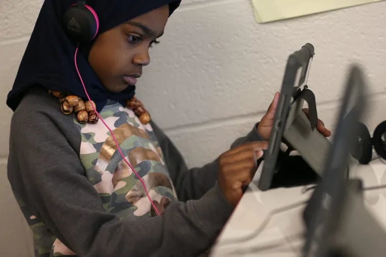 First-grader Lea Gant, 7, uses a reading program on an iPad in her classroom at Alain Locke Elementary School in West Philadelphia.