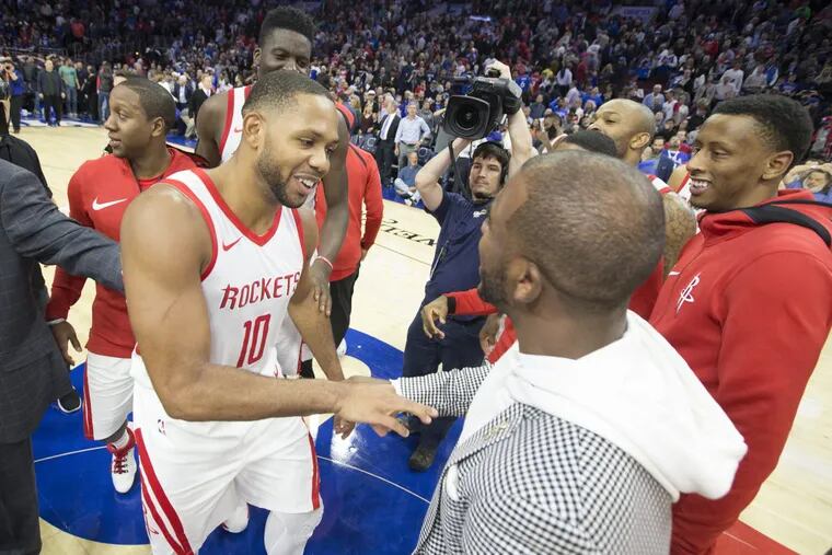 Eric Gordon, left, of the Houston Rockets is congratulated by teammate Chris Paul after hitting the game-winning three-pointer against the Sixers.