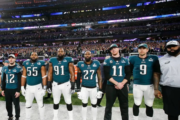 Longtime activist Malcolm Jenkins, 27, and quarterback Carson Wentz, 11, prepare for the coin toss in Minneapolis at Super Bowl LII. The city was the site of a killing of a black man by a police officer on Monday that caused Wentz and tight end Zach Ertz to join in Jenkins' pursuit of social justice.