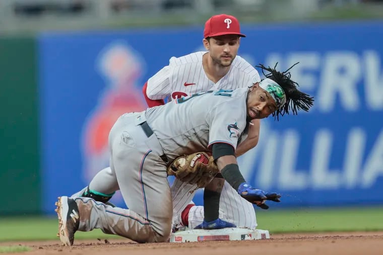 Trea Turner tags out Jean Segura during the second inning Tuesday.
