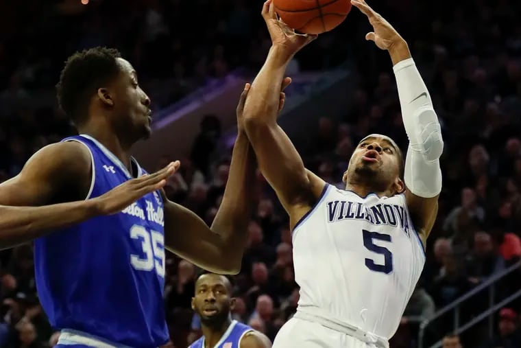 Villanova's Phil Booth gets fouled by Seton Hall center Romaro Gill during the first half of the Wildcats' win at the Wells Fargo Center on Sunday.