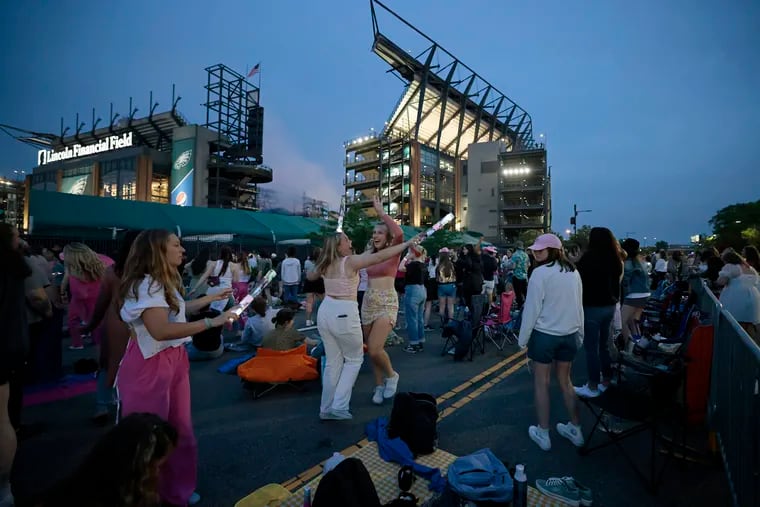Taylor Swift fans danced in the street after police closed South 11th Street between Lincoln Financial Field and the Wells Fargo Center on May 13, 2023.