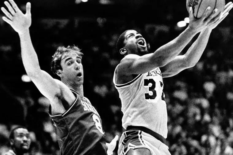 "Magic" Johnson of the Los Angeles Lakers, right, and Marc Iavaroni of the Philadelphia 76ers collide during first period action Sunday, May 29, 1983 in thier NBA championship series game in Los Angeles. (Reed Saxon/AP file photo)