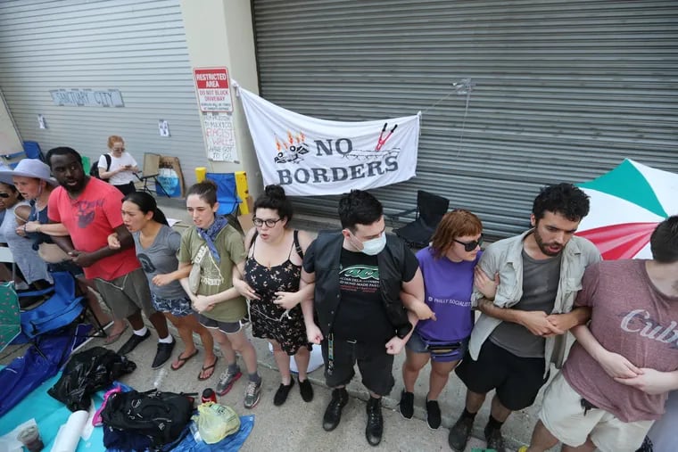 About a dozen protesters are arrested outside the Immigration and Customs Enforcement office in Center City after demanding an end to the agencyÕs policies and cooperation between the city of Philadelphia and ICE, Tuesday July 3, 2018.