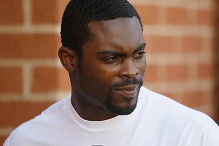 Michael Vick spoke with detectives at Virginia Beach Police headquarters yesterday. (Matt Rourke/AP file photo)