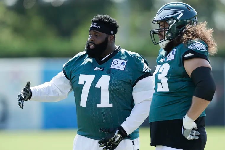 Eagles offensive tackle Jason Peters (left) talks to teammate offensive guard Isaac Seumalo during training camp at the NovaCare Complex in South Philadelphia on Monday August 17, 2020.