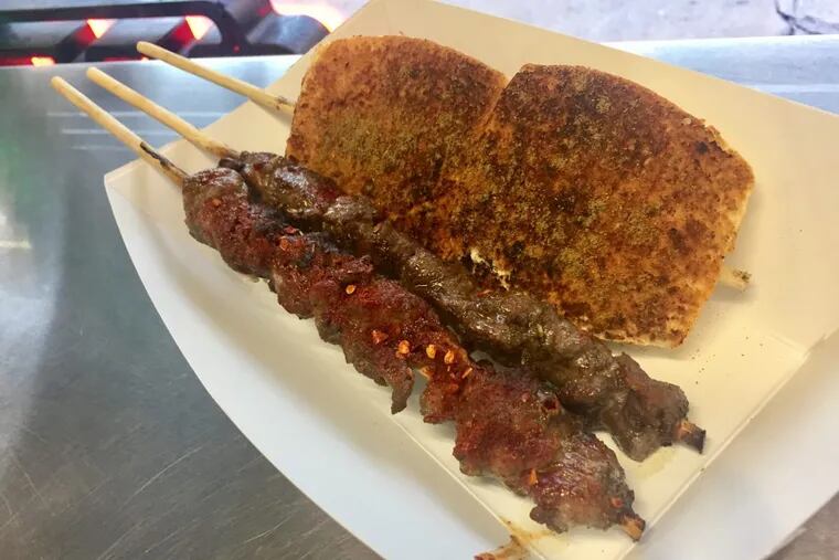 Charcoal-grilled skewers of beef, lamb, and buns at TT Skewer in Chinatown.