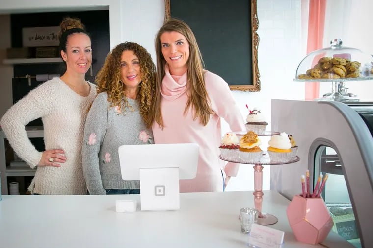 The owners of the Conshohocken location of Pretty Tasty Cupcakes are (from left) Erica Young, Kim Strengari, and Gabby Wallace.