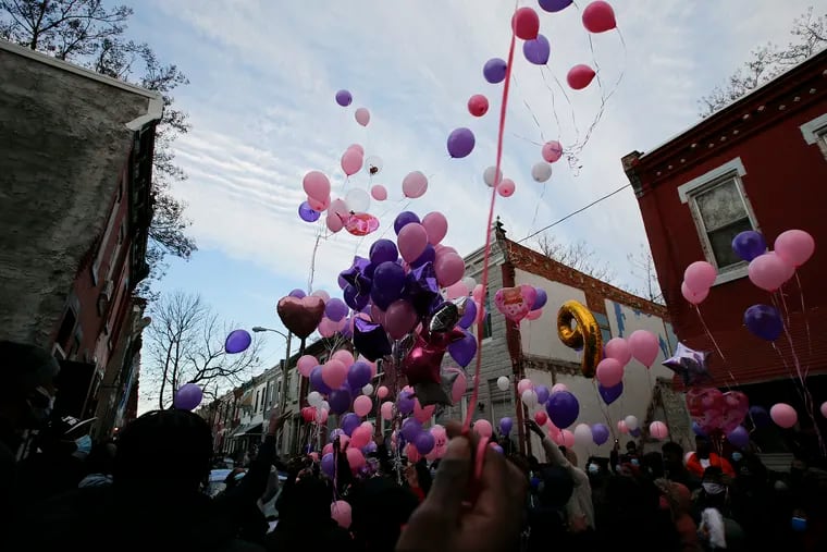 Residents release balloons Thursday in memory of a 9-year-old girl who died after an accidental shooting in a home on the 2300-Block of North Bouvier Street in North Philadelphia.
