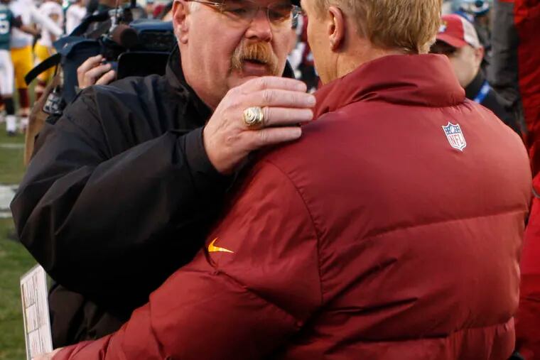 Andy Reid is embraced by Redskins defensive coordinator Jim Haslett after Washington beat the Eagles in what could be Reid's last home game. RON CORTES / Staff